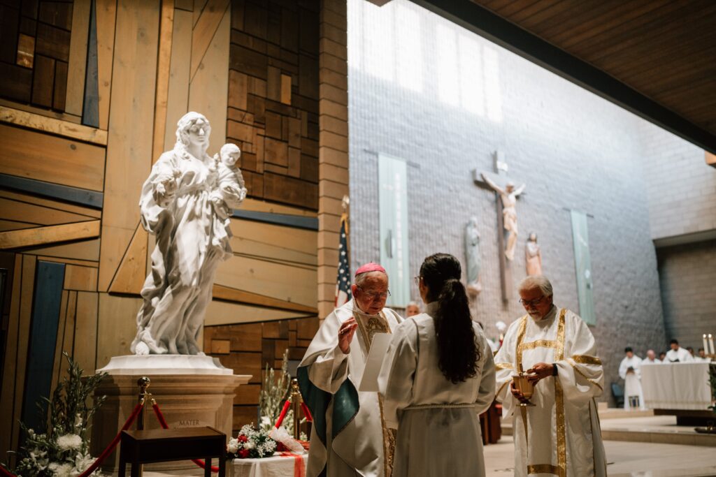 El arzobispo José H. Gomez frente a la imagen de María, Madre del Amor Hermoso, mientras consagra a los fieles a la Virgen en la iglesia St. Louise de Marillac en Covina, el 26 de junio. (Peter Lobato)