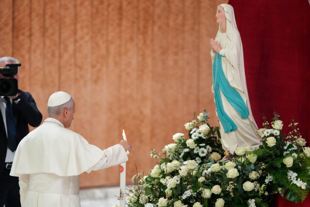 El Papa León XIV enciende una vela y reza ante una imagen de Nuestra Señora de Lourdes antes de su audiencia general semanal en el Aula Pablo VI del Vaticano, el 11 de febrero de 2026. El Papa encabezará un rosario mundial por la paz desde los jardines vaticanos el 30 de mayo. (CNS photo/Lola Gomez)