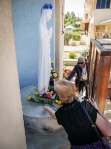 Parishioners at Sacred Heart Church in Lancaster lay flowers at the feet of the Virgin Mary in a May crowning event. (Katie Trejo)