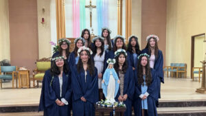 Students at St. Ignatius of Loyola School in Highland Park pose around a crowned statue of the Virgin Mary during a May crowning ceremony. (St. Ignatius of Loyola)