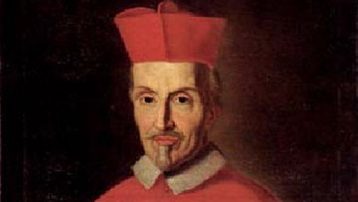 Portrait of a man in red cardinal robes and hat, facing forward.