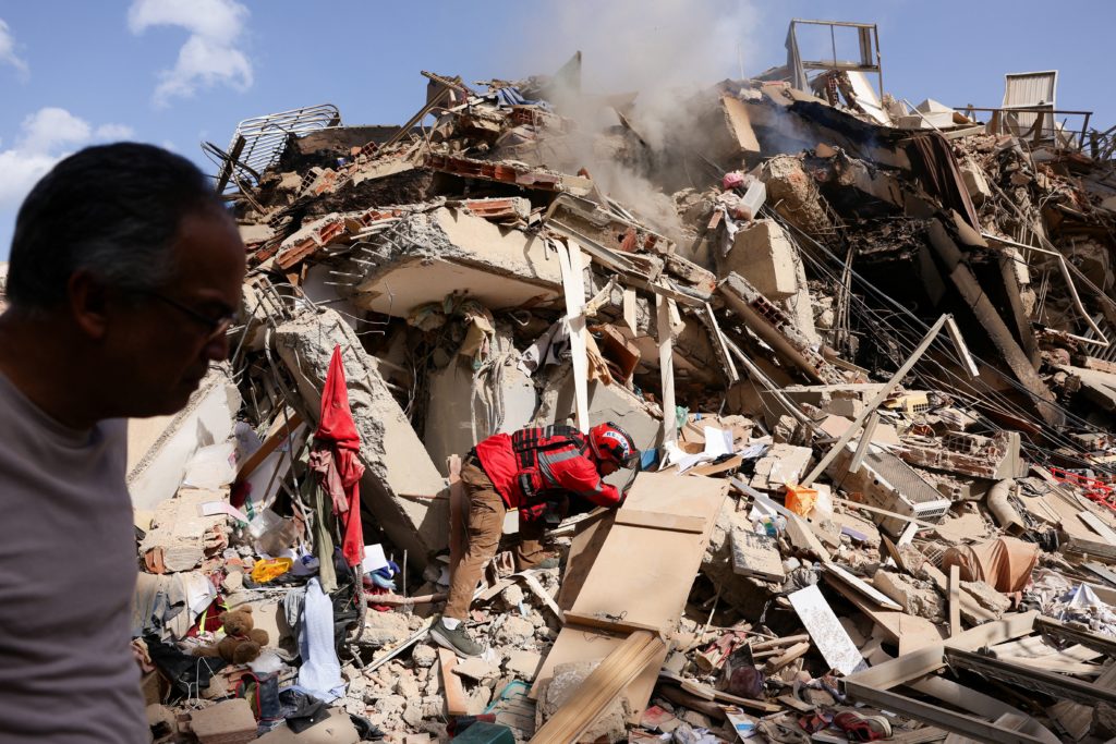 Juan Carlos Gomez, a firefighter from Caracas, looks for his sister, Katiuska Hernandez, and nephew Brett Roude, amid the rubble of a building in La Guaira, Venezuela, June 25, 2026, following 7.2 and 7.5 magnitude earthquakes that rocked the country June 24. Venezuelans searched for survivors beneath collapsed buildings June 25, and rescue teams raced to northern areas hit hard by the twin quakes that officials say killed nearly 200 people and left hundreds trapped. More were feared dead. (OSV News photo/Maxwell Briceno, Reuters)