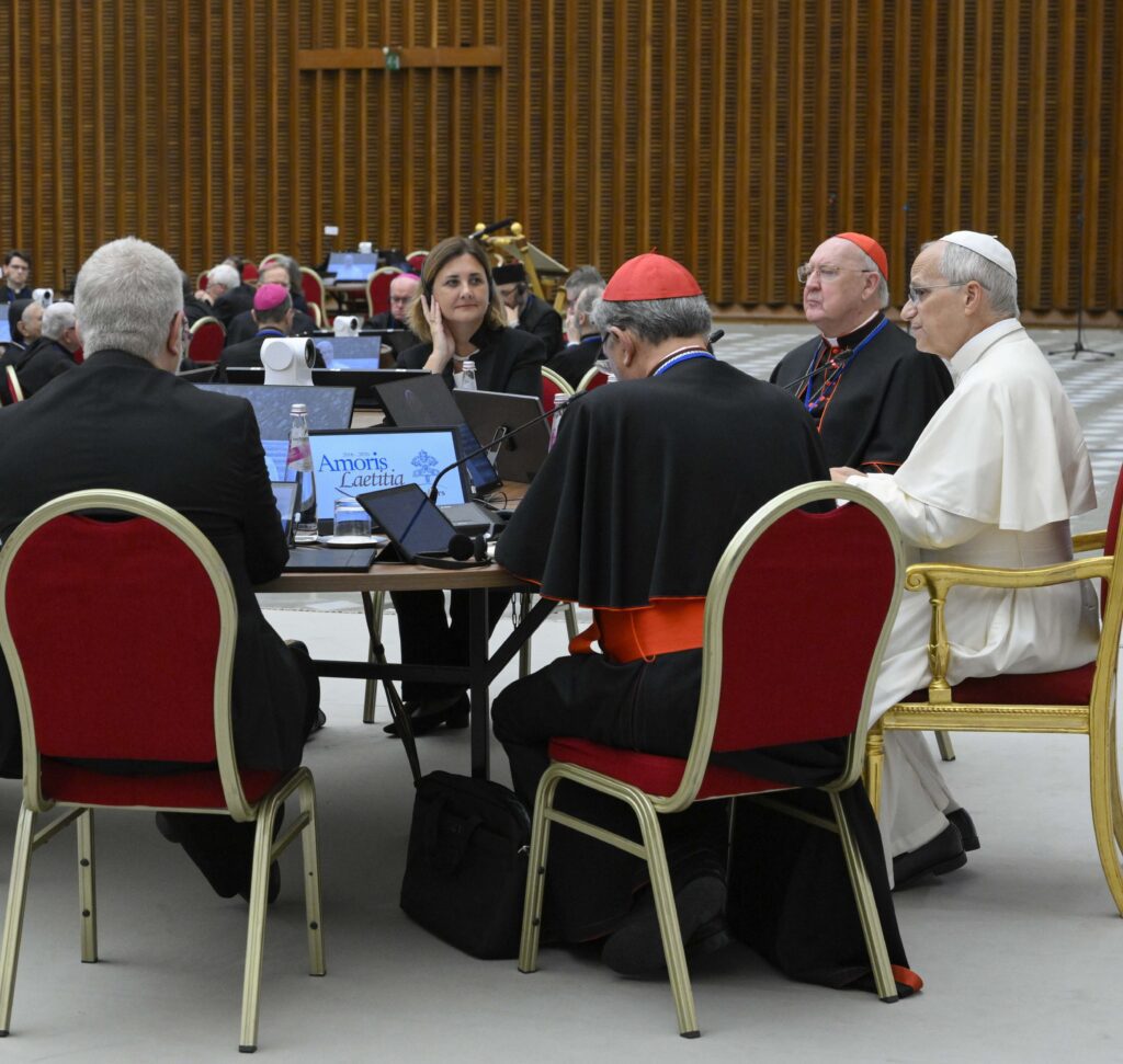 El papa León XIV conversa en una mesa con prelados y laicos el 7 de octubre de 2026, tras inaugurar en el Vaticano el encuentro de una semana de duración con los presidentes de las conferencias episcopales, convocado para conmemorar el décimo aniversario de Amoris Laetitia (“La alegría del amor”). El 8 de octubre, segundo día del encuentro, el cardenal Filipe Neri Ferrão, de Goa, India, compartió con los obispos reunidos en el Vaticano los buenos resultados obtenidos por una parroquia de su arquidiócesis gracias a las visitas pastorales a las familias y las noches familiares sin celulares. (Foto de OSV News/Simone Risoluti, Vatican Media)