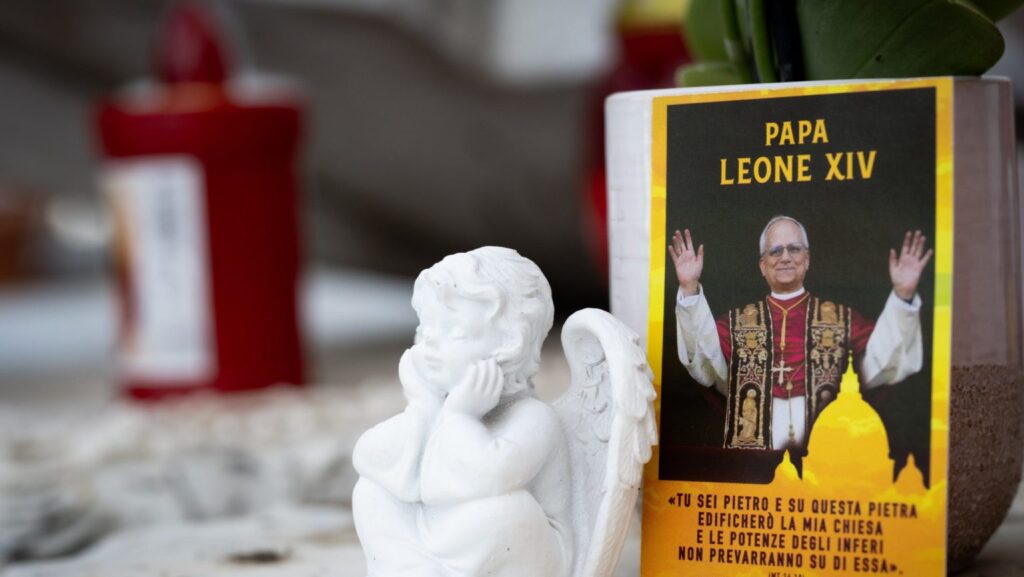 Una fotografía del papa León XIV junto a objetos devocionales, colocada sobre la estatua de san Juan Pablo II frente al Hospital Gemelli de Roma, donde el Pontífice se recupera de una cirugía en la que le extirparon el lóbulo inferior derecho del pulmón para tratar un tumor canceroso. (Foto de CNS/Cristian Gennari)