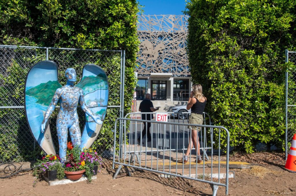 La escultura del ángel azul que estaba junto a Corpus Christi y sobrevivió al incendio de Palisades acompaña a los voluntarios cerca de uno de los lugares de trabajo. (Mike Goulding)